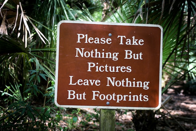 A sign at a state park reminding people to not leave their trash behind- a key part of land conservation.