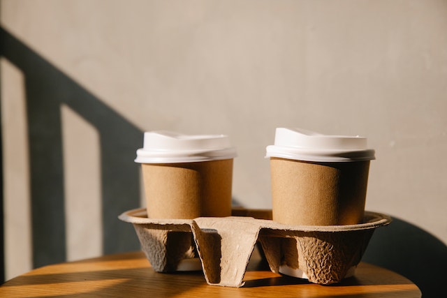 Cardboard coffee cups on a tray.