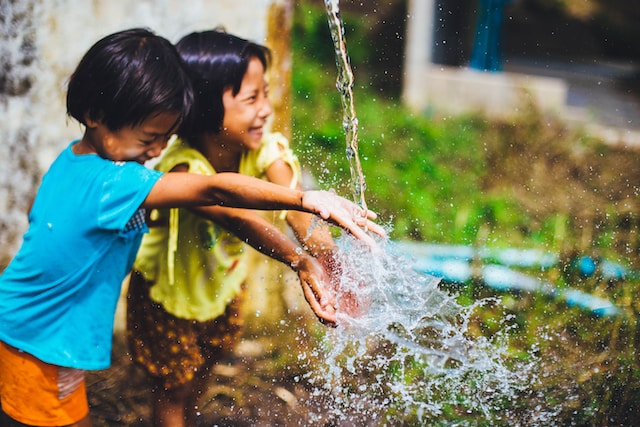 Two kids playing with water