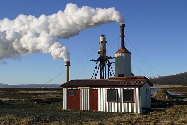 Clouds of white steam coming out of the towers at a small geothermal power plant