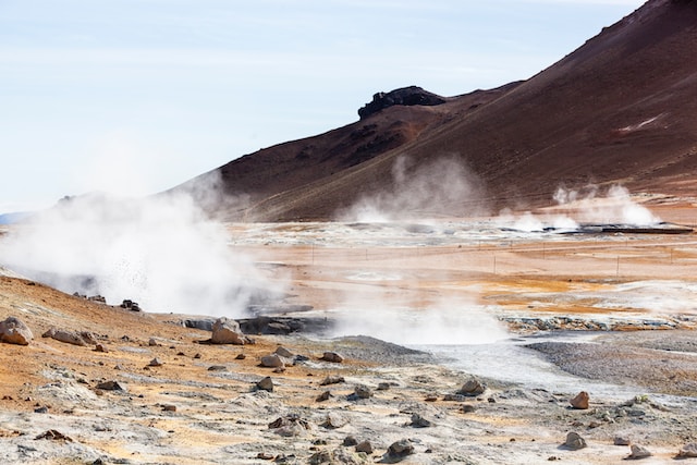 Steam rises from a geothermally active land