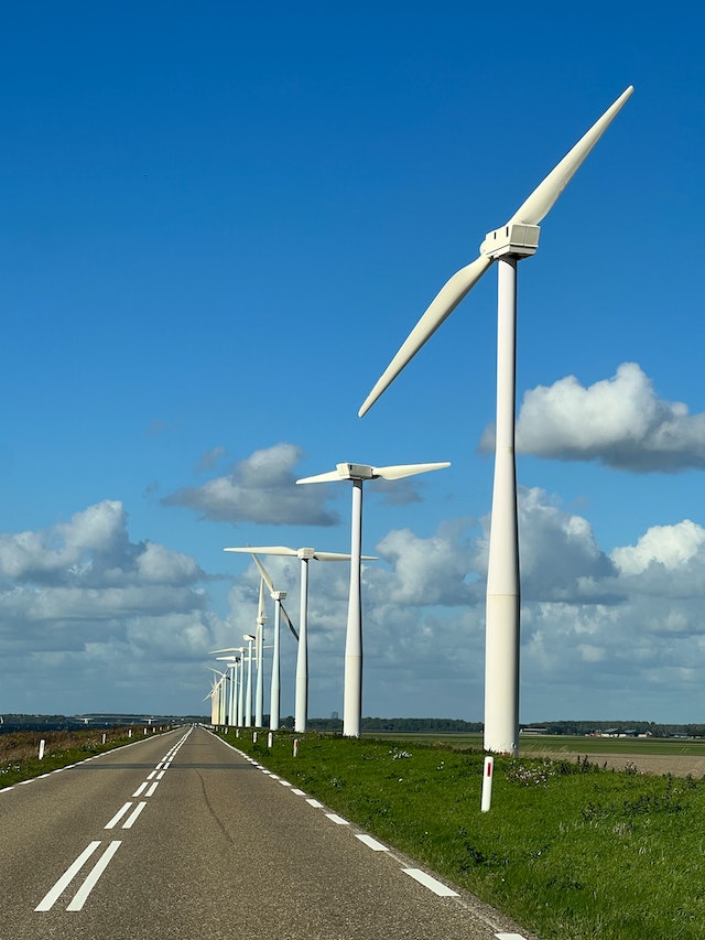 Wind turbines on the side of a concrete road