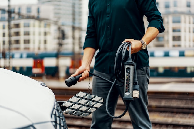 Person holding a portable car charger